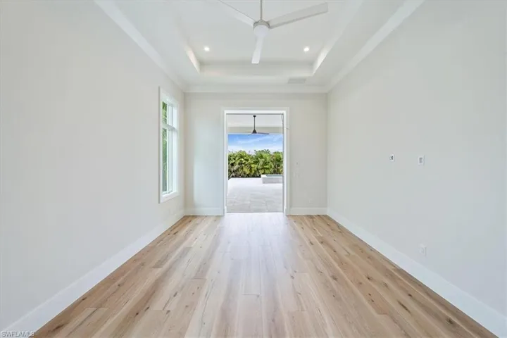 The primary suite features impact glass 10' sliders leading to the outdoor fireplace. Dual walk-in closets feature copewood shelving for ample storage.