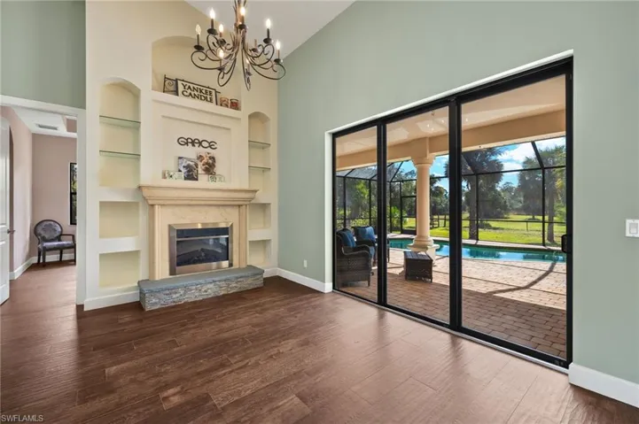 Unfurnished living room with plenty of natural light, dark wood-type flooring, and built in features