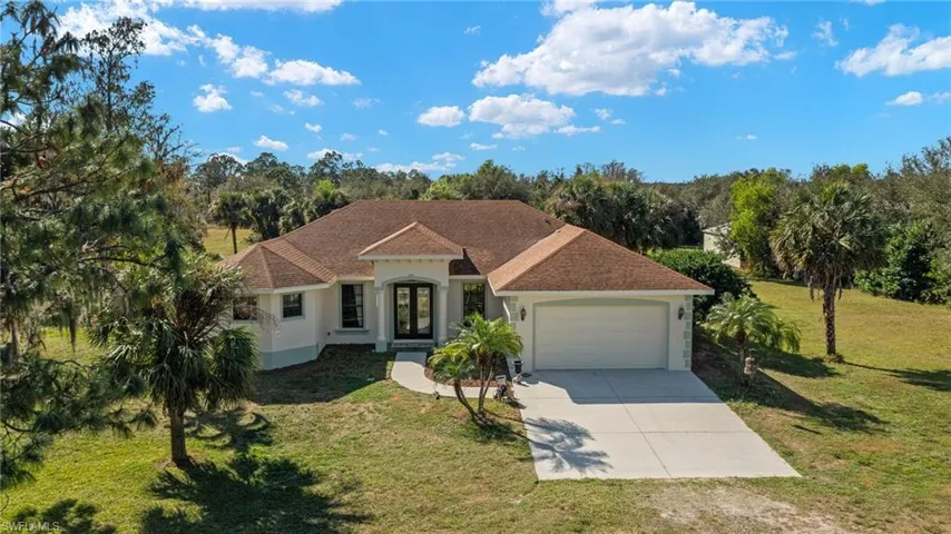 View of front of house with a garage and a front yard