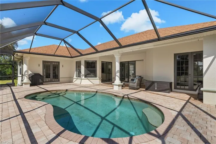 Back of house with a patio, a lanai, and french doors