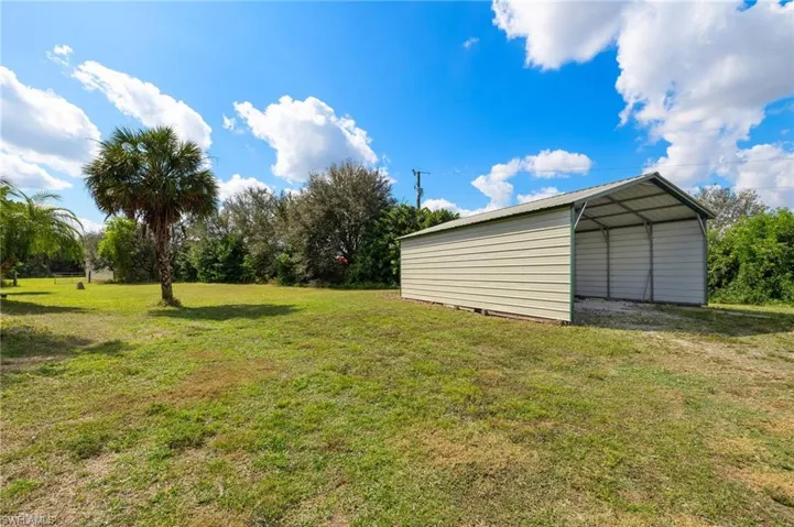 View of yard with a carport
