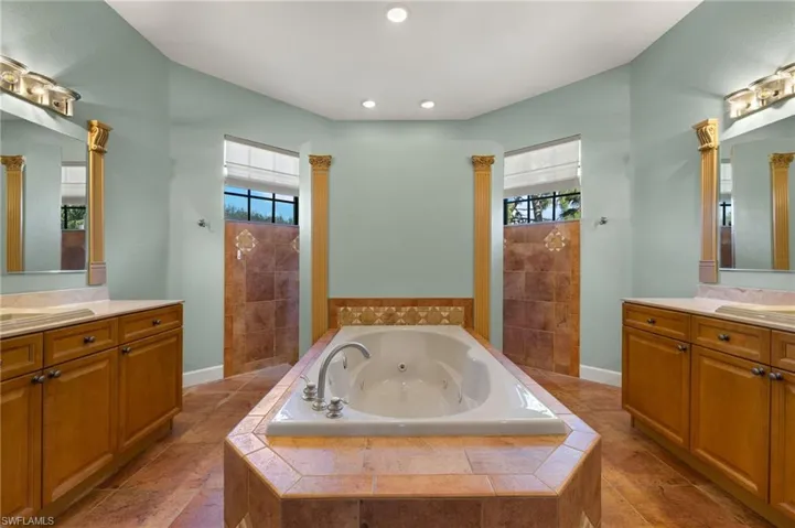 Bathroom with vanity, separate shower and tub, and a healthy amount of sunlight
