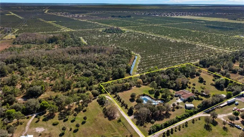 Birds eye view of property with a rural view and a water view