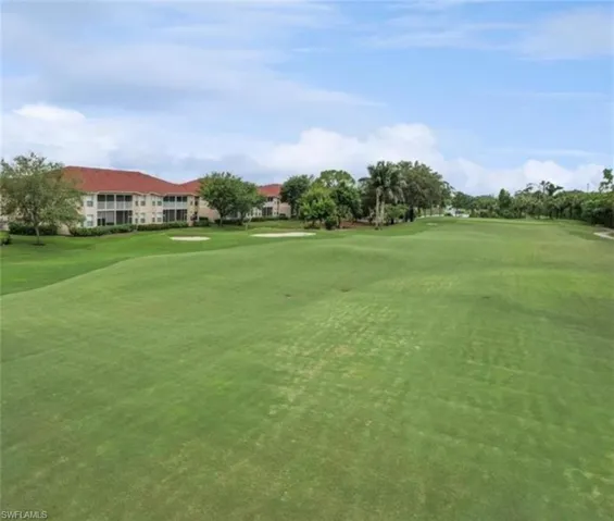 View of community featuring golf course view and a lawn