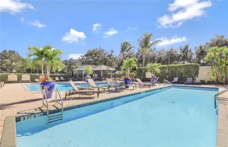 Pool with a patio area, fence, and a gazebo