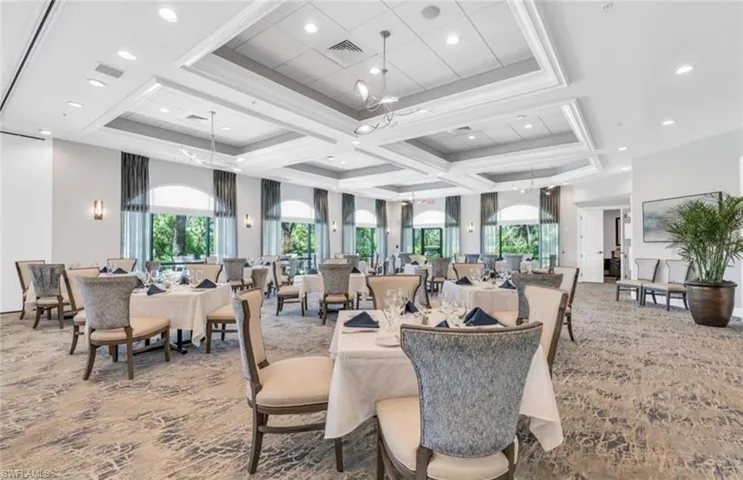 Dining area with coffered ceiling, carpet, visible vents, and ornamental molding