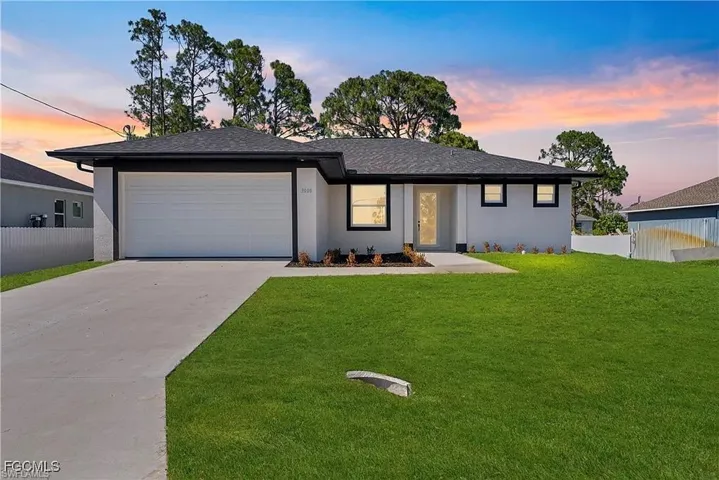 Contemporary single-story residence with a dark shingle roof and light gray stucco exterior