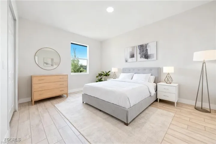 Spacious room featuring wood-finish flooring, a contemporary window, and ample natural light