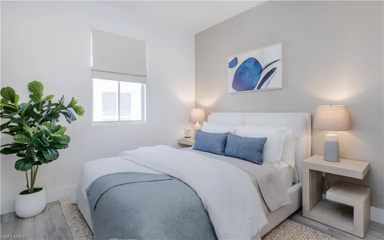 Bedroom with light hardwood / wood-style flooring