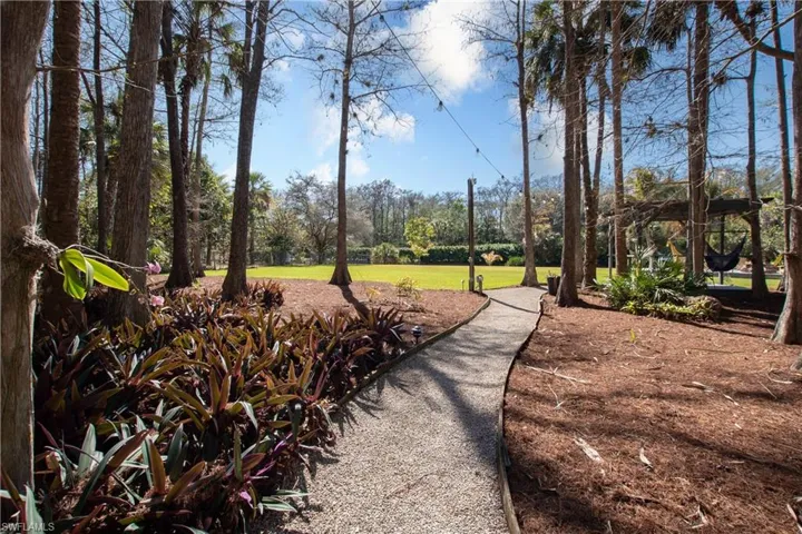 Shell Walkway through Cypress Trees to Backyard