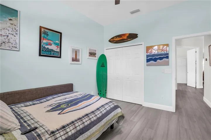 Bedroom featuring hardwood / wood-style flooring, a closet, and ceiling fan