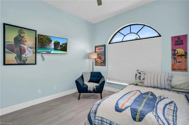 Bedroom with ceiling fan and wood-type flooring