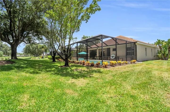 View of yard with glass enclosure and a swimming pool