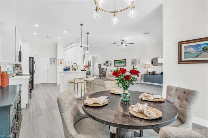 Dining area featuring sink, light wood-type flooring, and ceiling fan