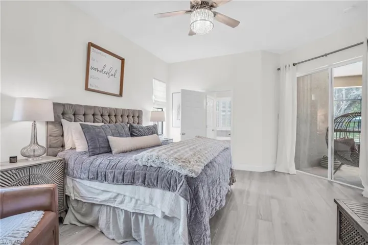 Bedroom featuring access to exterior, ceiling fan, and light hardwood / wood-style flooring