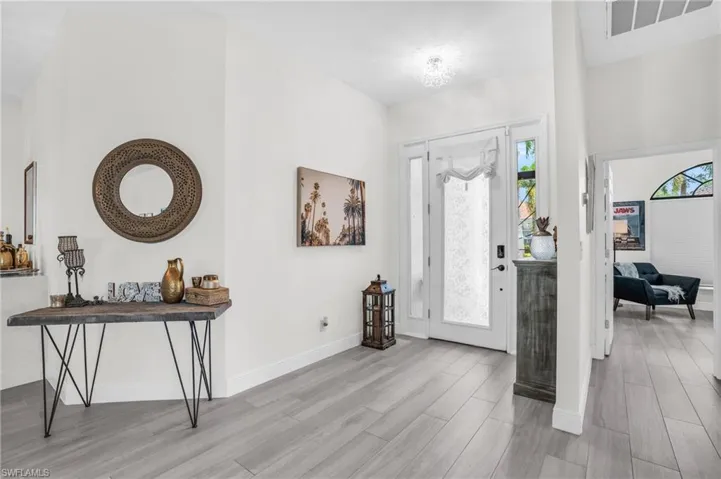 Foyer entrance featuring light hardwood / wood-style floors and a wealth of natural light