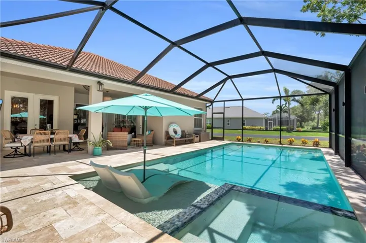 View of pool featuring an outdoor living space, a patio, and a lanai