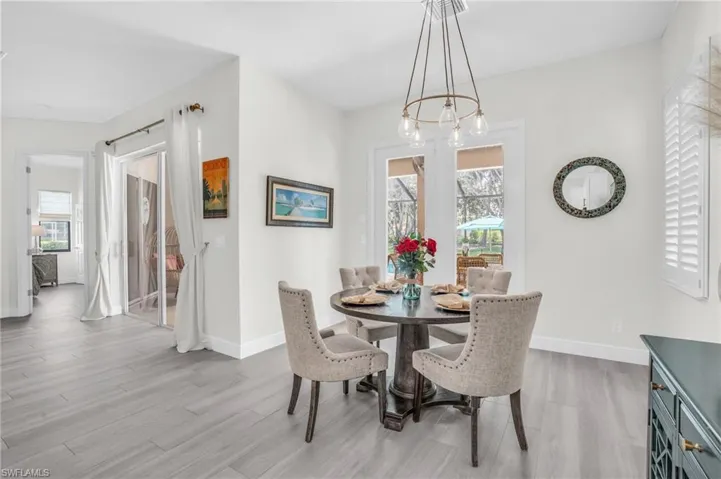 Dining space featuring wood-type flooring and a chandelier