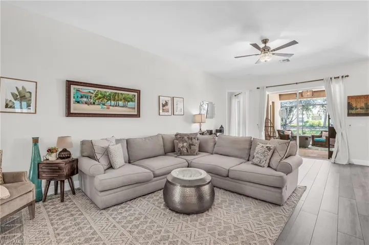 Living room with light hardwood / wood-style flooring and ceiling fan