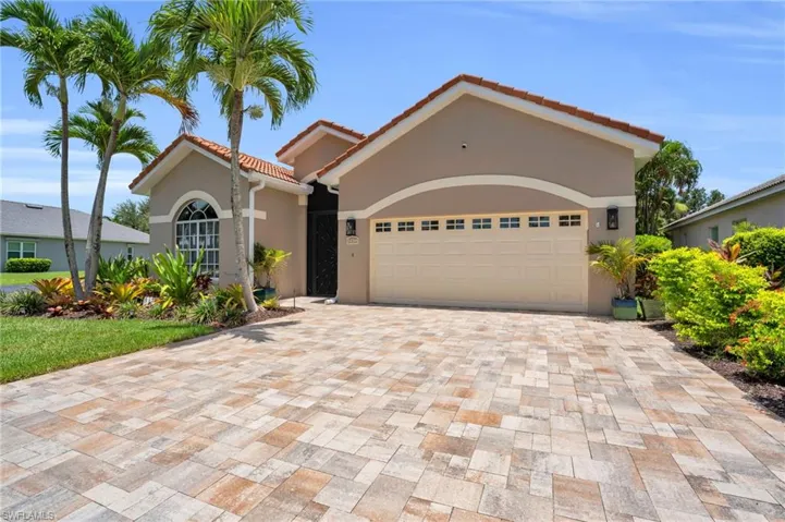 Mediterranean / spanish home featuring a garage