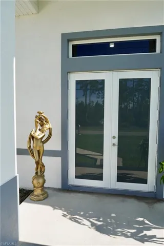 Property entrance with french doors and stucco siding