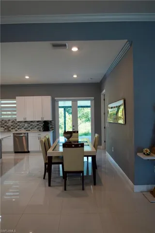 Dining room featuring crown molding, light tile patterned floors, and recessed lighting