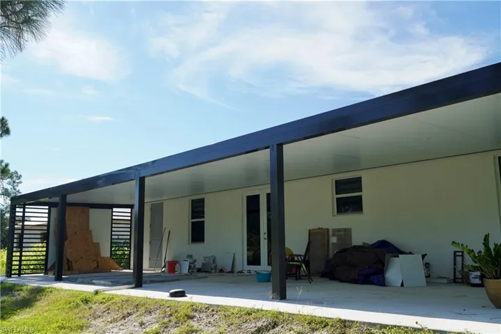 Back of property with stucco siding and a patio
