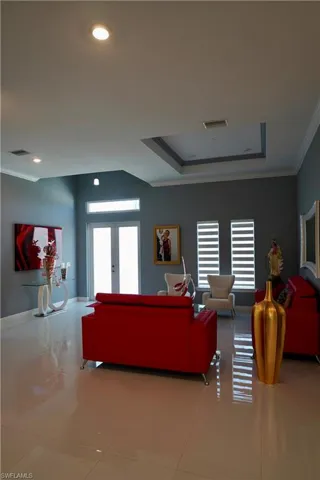 Tiled living area with plenty of natural light and a raised ceiling