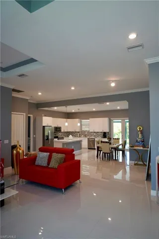 Living room featuring ornamental molding and recessed lighting