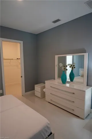 Bedroom with a spacious closet and light tile patterned floors