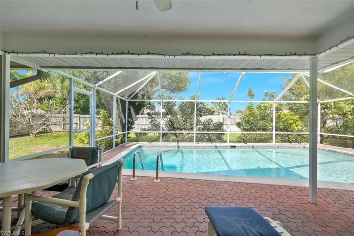 View of pool with a patio area, a fenced backyard, a fenced in pool, and a lanai