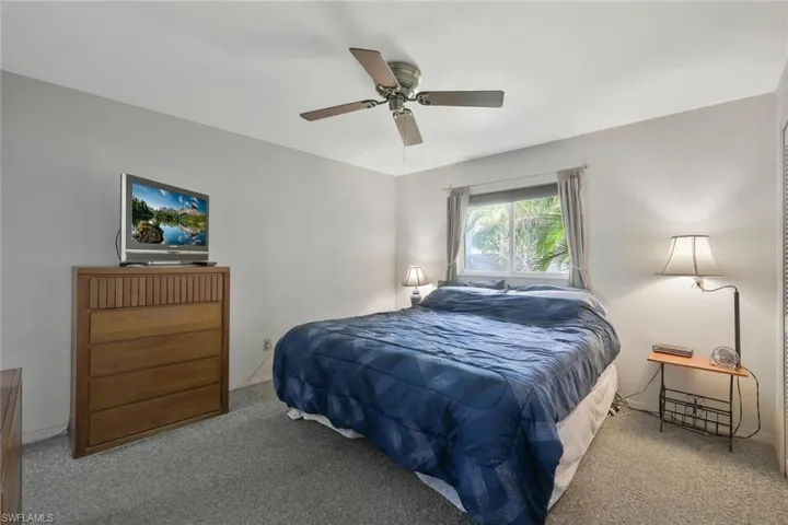 Carpeted bedroom with ceiling fan