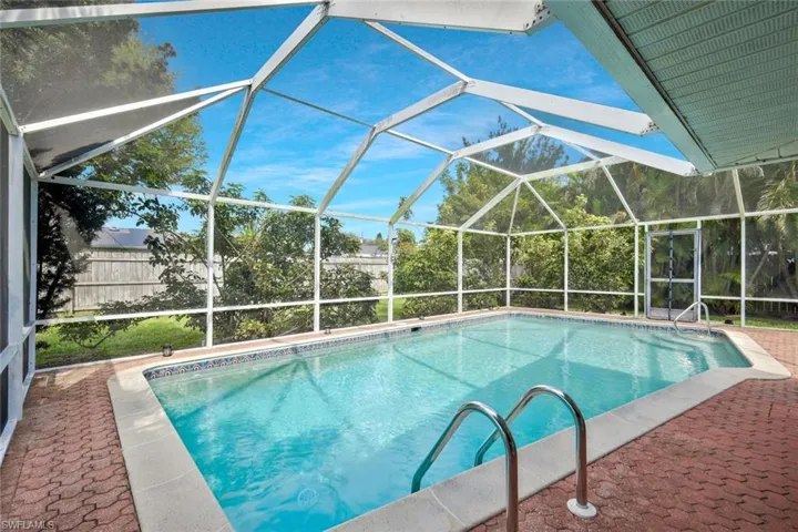 View of pool featuring a lanai, fence, a fenced in pool, and a patio