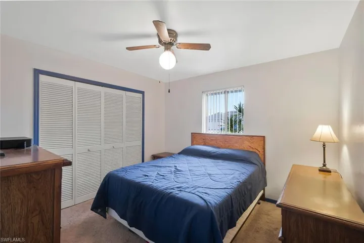 Bedroom featuring ceiling fan, a closet, and carpet flooring