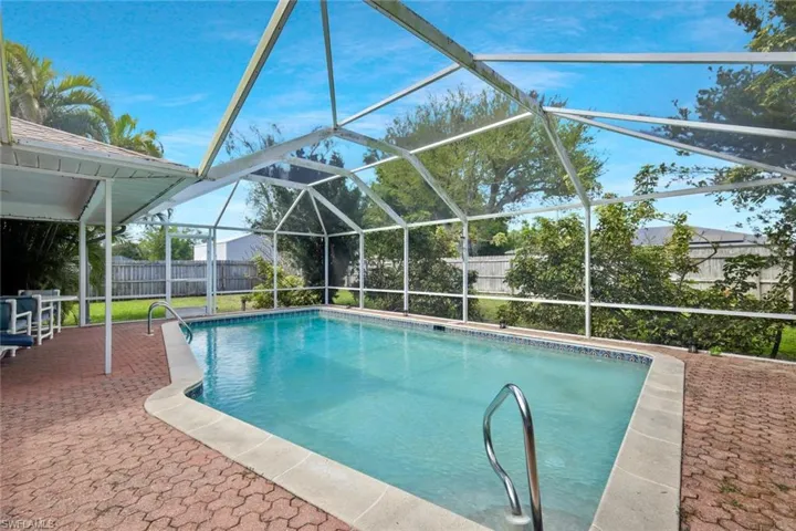 View of swimming pool with a lanai, a fenced backyard, a fenced in pool, and a patio