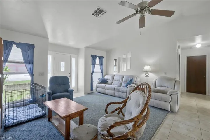Living room with visible vents and light tile patterned flooring