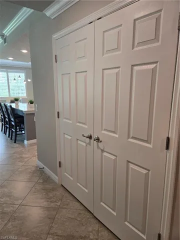 Interior details featuring crown molding and tile patterned flooring