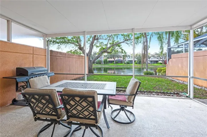 Sunroom / solarium featuring a water view