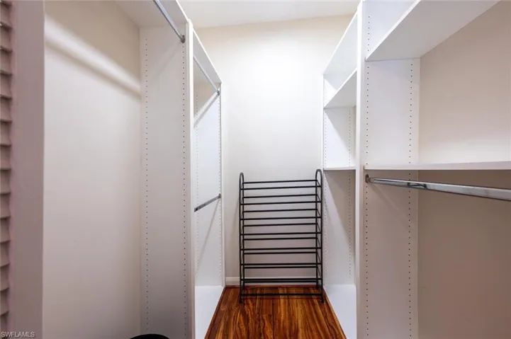 Walk in closet featuring wood finished floors