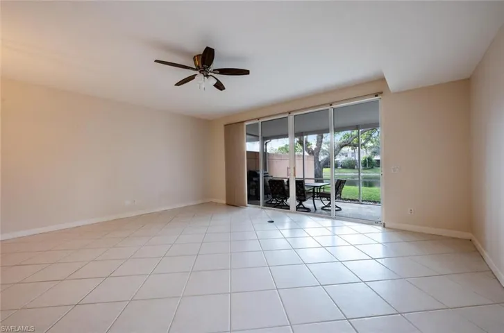 Unfurnished room with ceiling fan, baseboards, and light tile patterned flooring