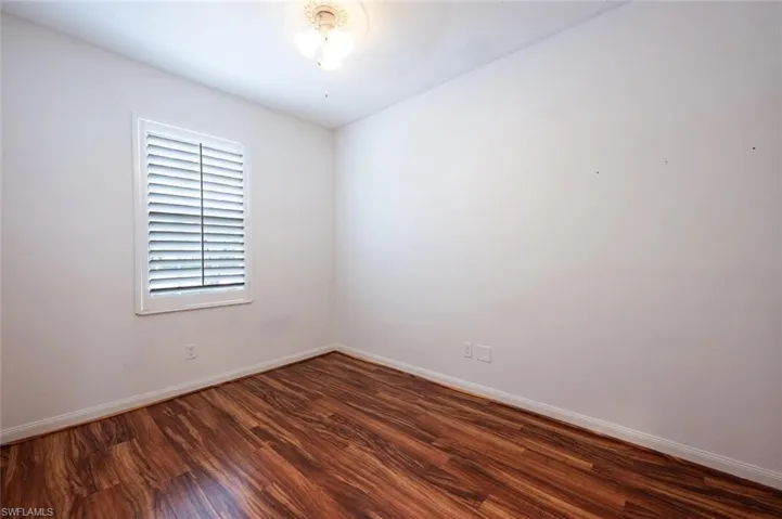 Empty room featuring wood finished floors and baseboards