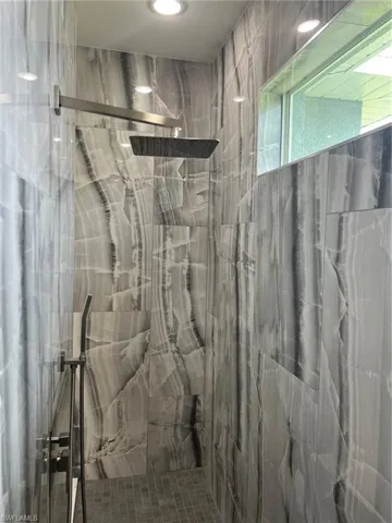 Bathroom featuring a tile shower
