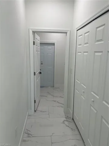 Corridor with light tile flooring