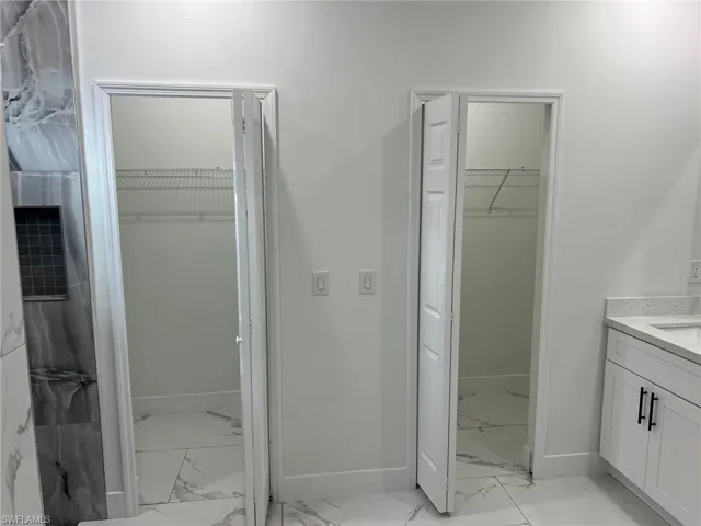 Bathroom featuring tile flooring and vanity