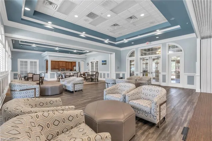 Common area with ornamental molding and a decorative wall
