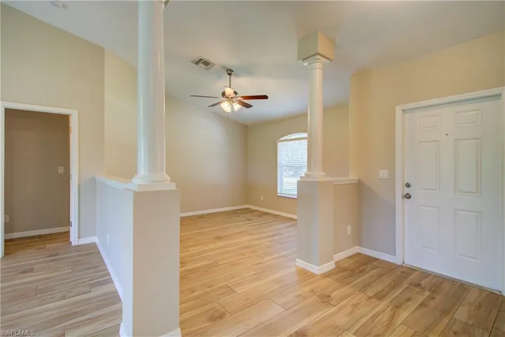 Foyer entrance featuring light wood-style floors and ceiling fan