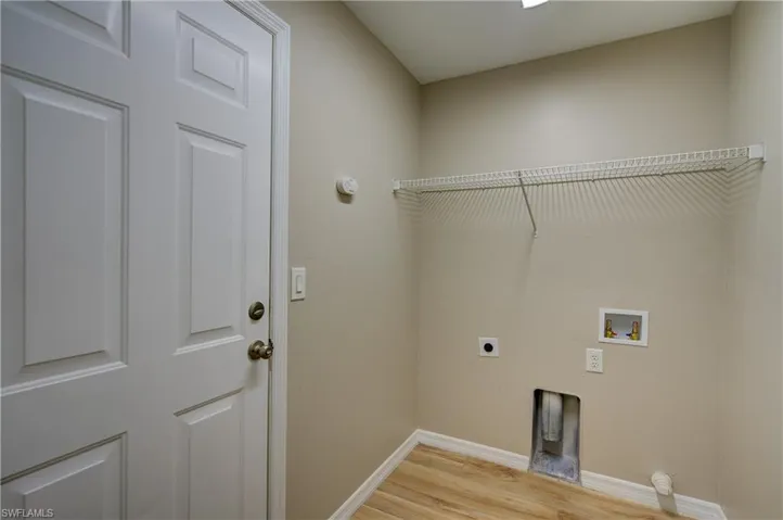 Laundry area featuring light wood-type flooring, hookup for an electric dryer, and washer hookup