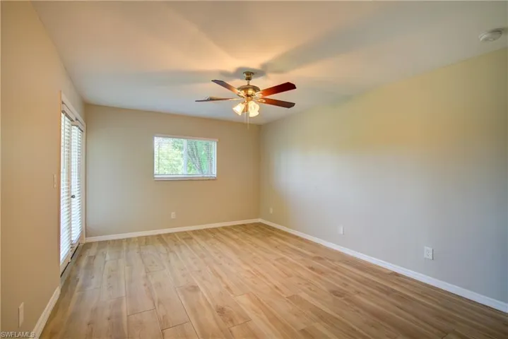 Unfurnished bedroom featuring light wood-style floors and ceiling fan
