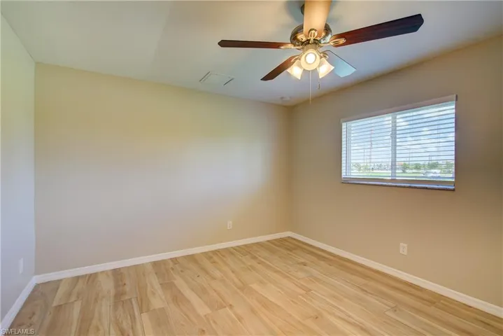 Empty room with light wood-type flooring and ceiling fan