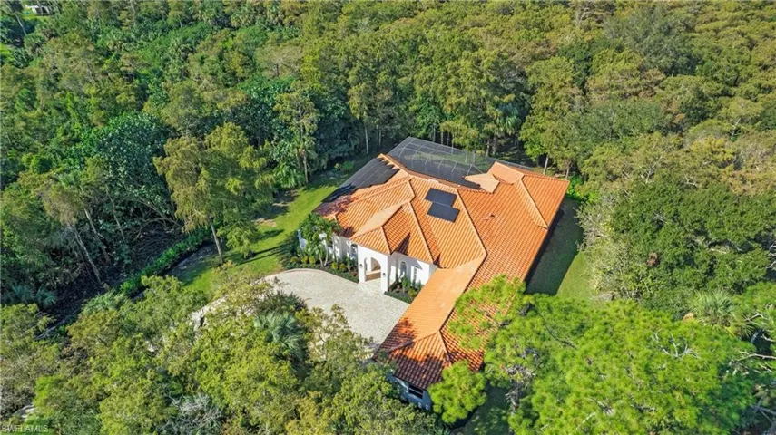 View from above of property with a heavily wooded area